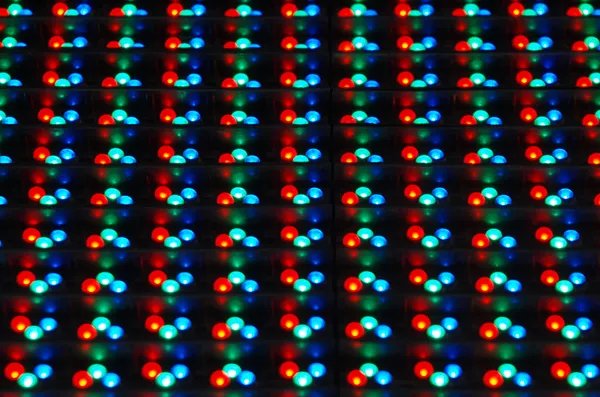 Closeup of tiny red, green and blue LEDs arranged in a matrix for a display.