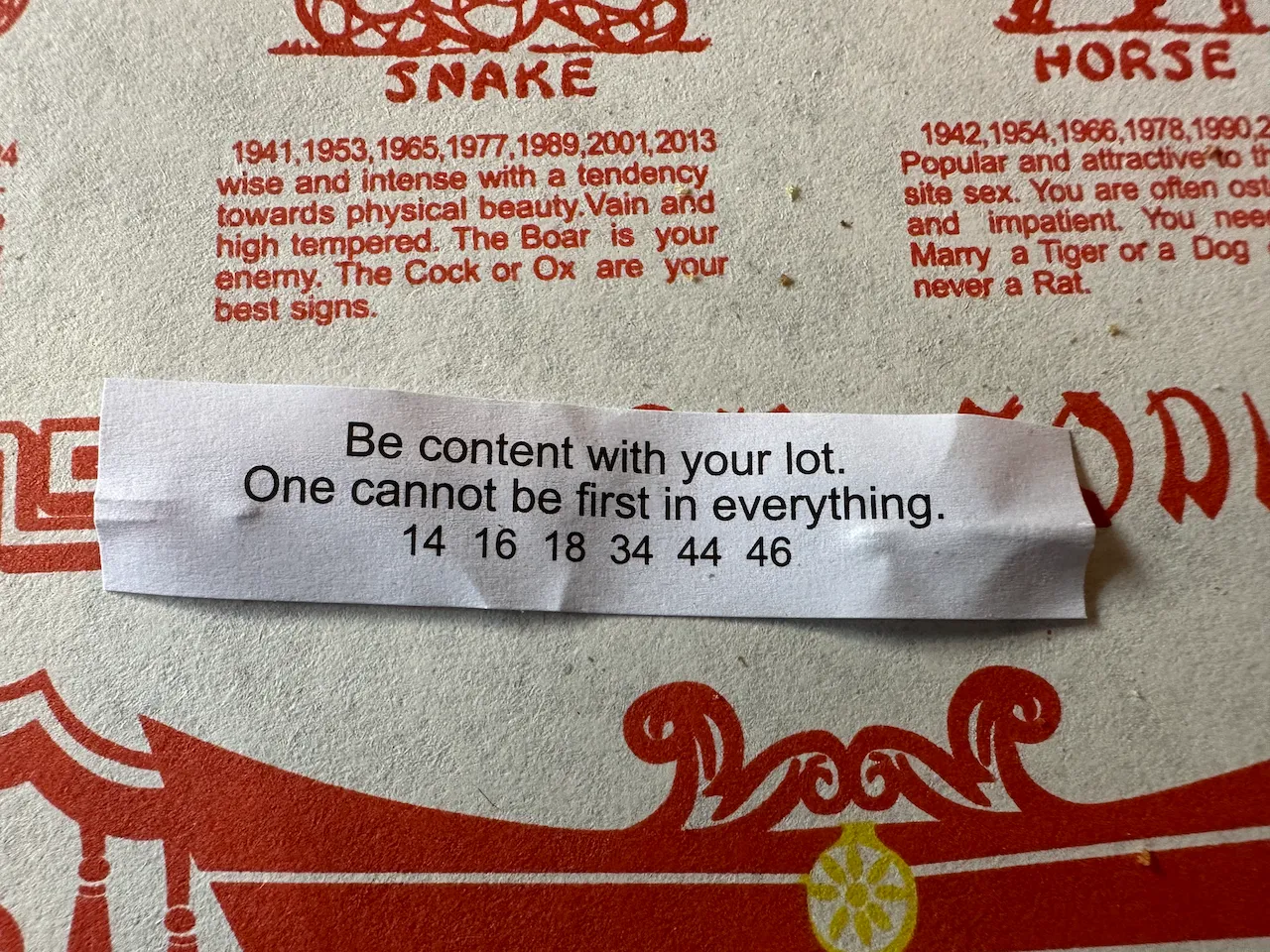 A fortune from a fortune cookie, which reads Be content with your lot, one cannot be first in everything.