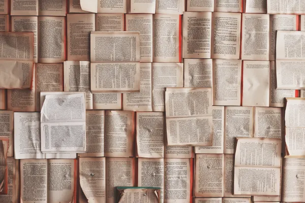 Open books spread out on a table.