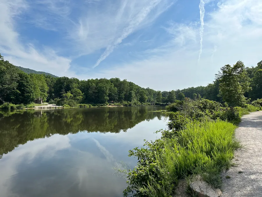 A sunny day at Pandapas pond, with the bright blue sky and scattered clouds reflected perfectly in the water.